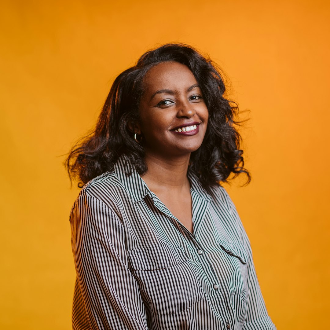 Studio portrait of a Brazilian woman with curly hair smiling