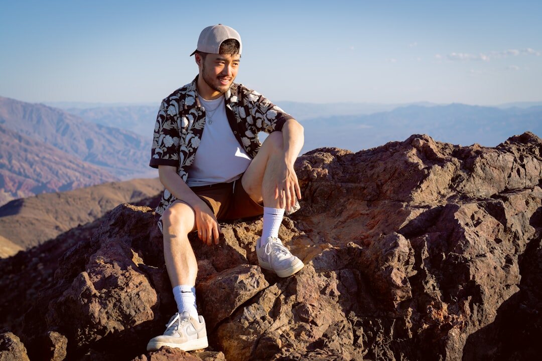 person climbing mountain peak