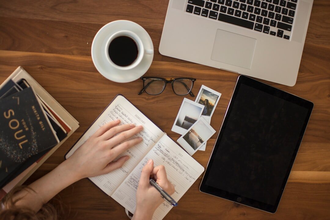 person writing in journal