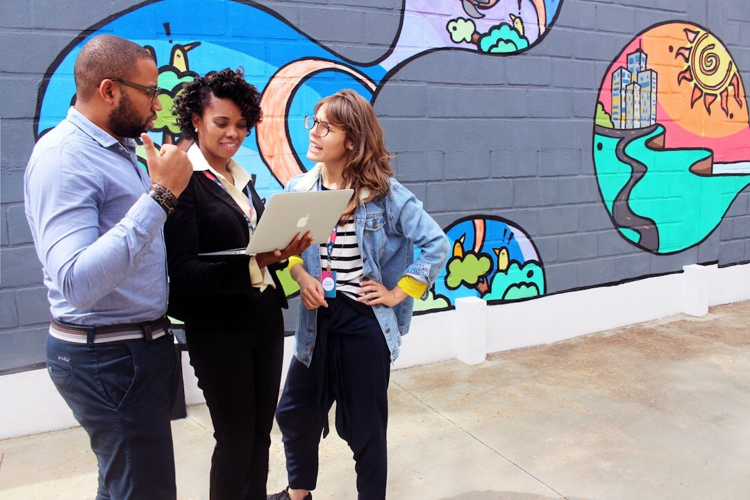 Small group of Brazilian coworkers discussing around a table