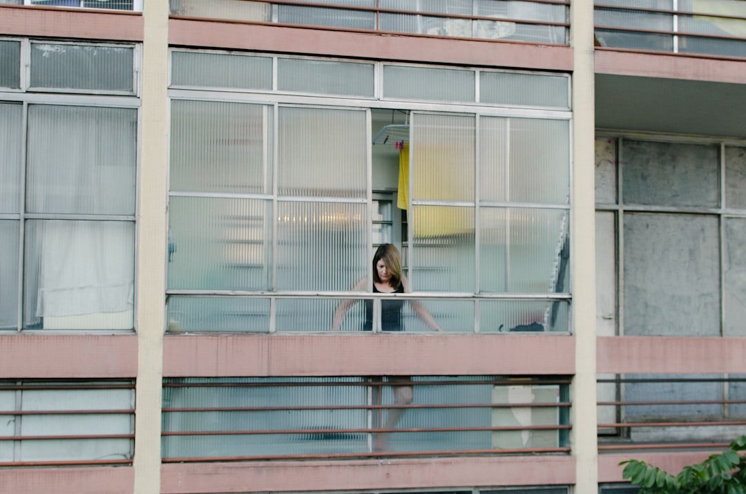 Brazilian woman writing in a journal near a window